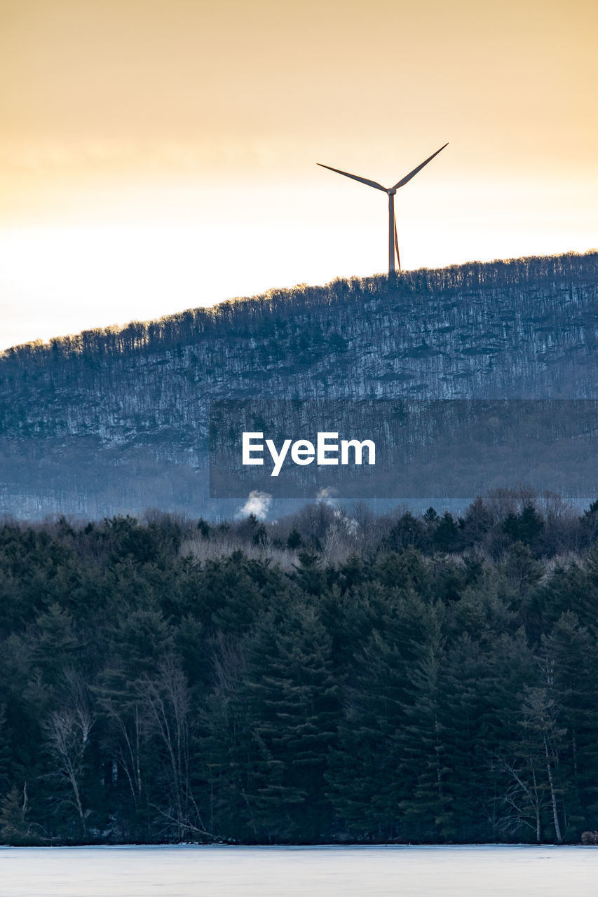 Silhouette of a windmill against sky during sunset