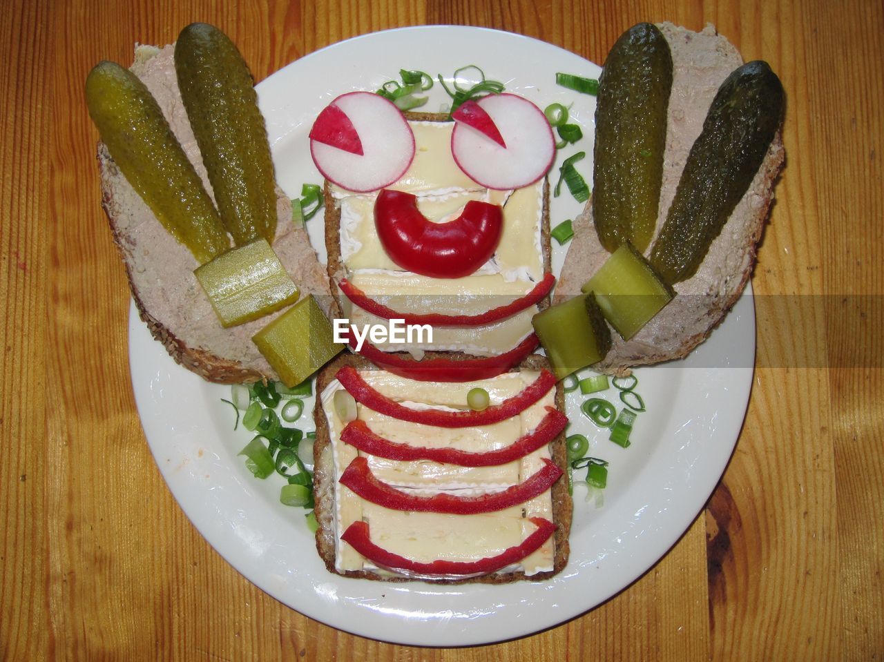 High angle view of face made by sandwich in plate on table