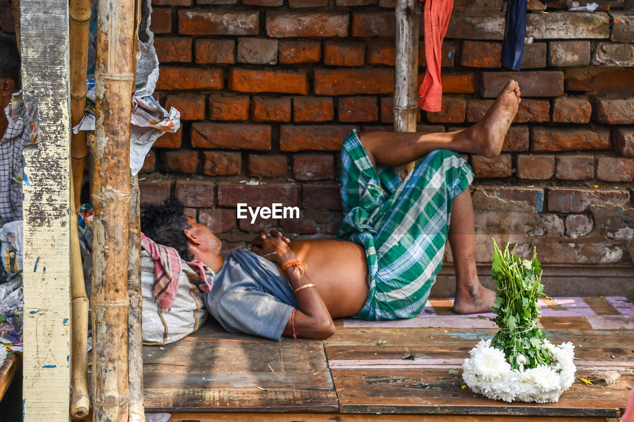 MAN SITTING ON WALL