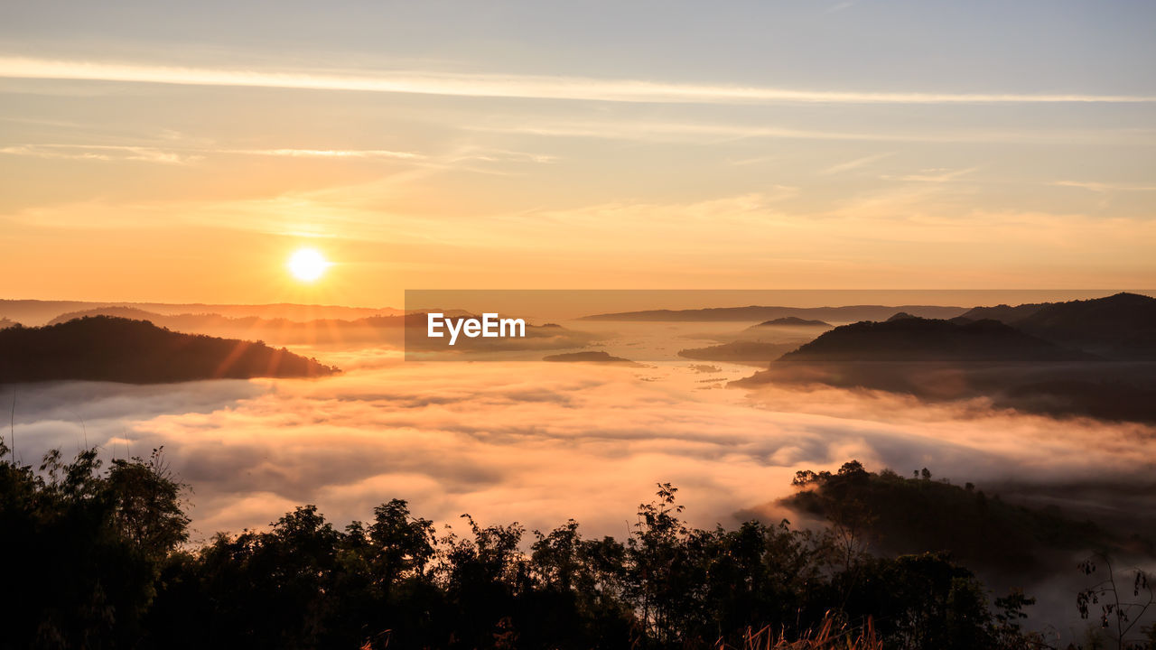 Scenic view of silhouette mountains against sky during sunset