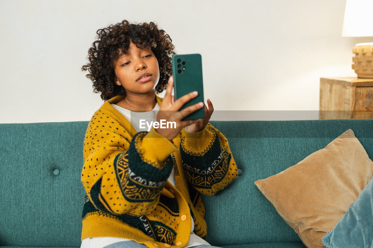 portrait of young woman using mobile phone