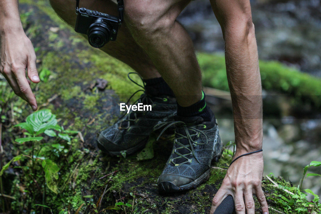 Low section of man hiking in forest