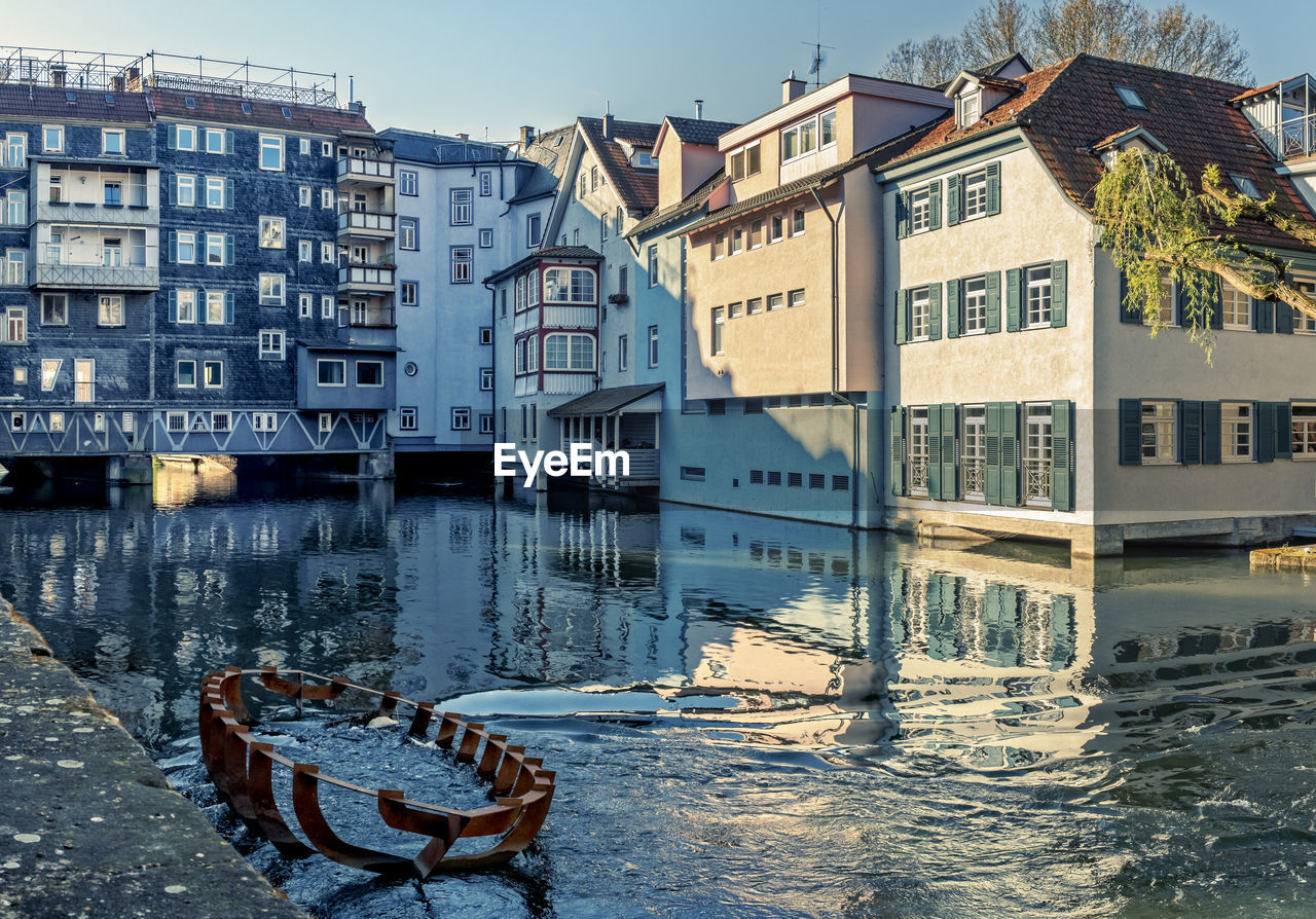 CANAL AMIDST HOUSES IN CITY