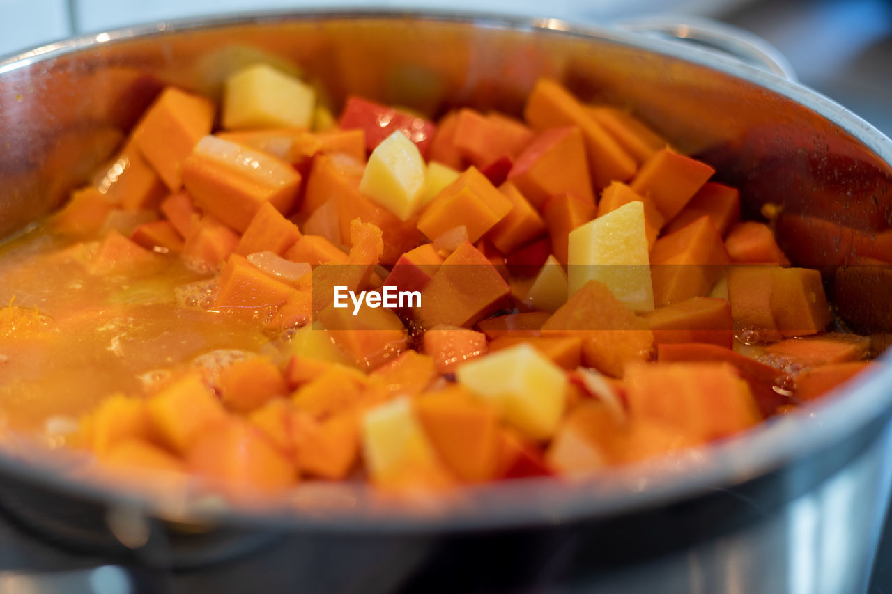 food and drink, food, vegetable, carrot, dish, healthy eating, cooking pan, root vegetable, kitchen utensil, produce, household equipment, wellbeing, stew, selective focus, pumpkin, freshness, onion, indoors, bowl, no people, close-up, spice, kitchen, raw potato, domestic room