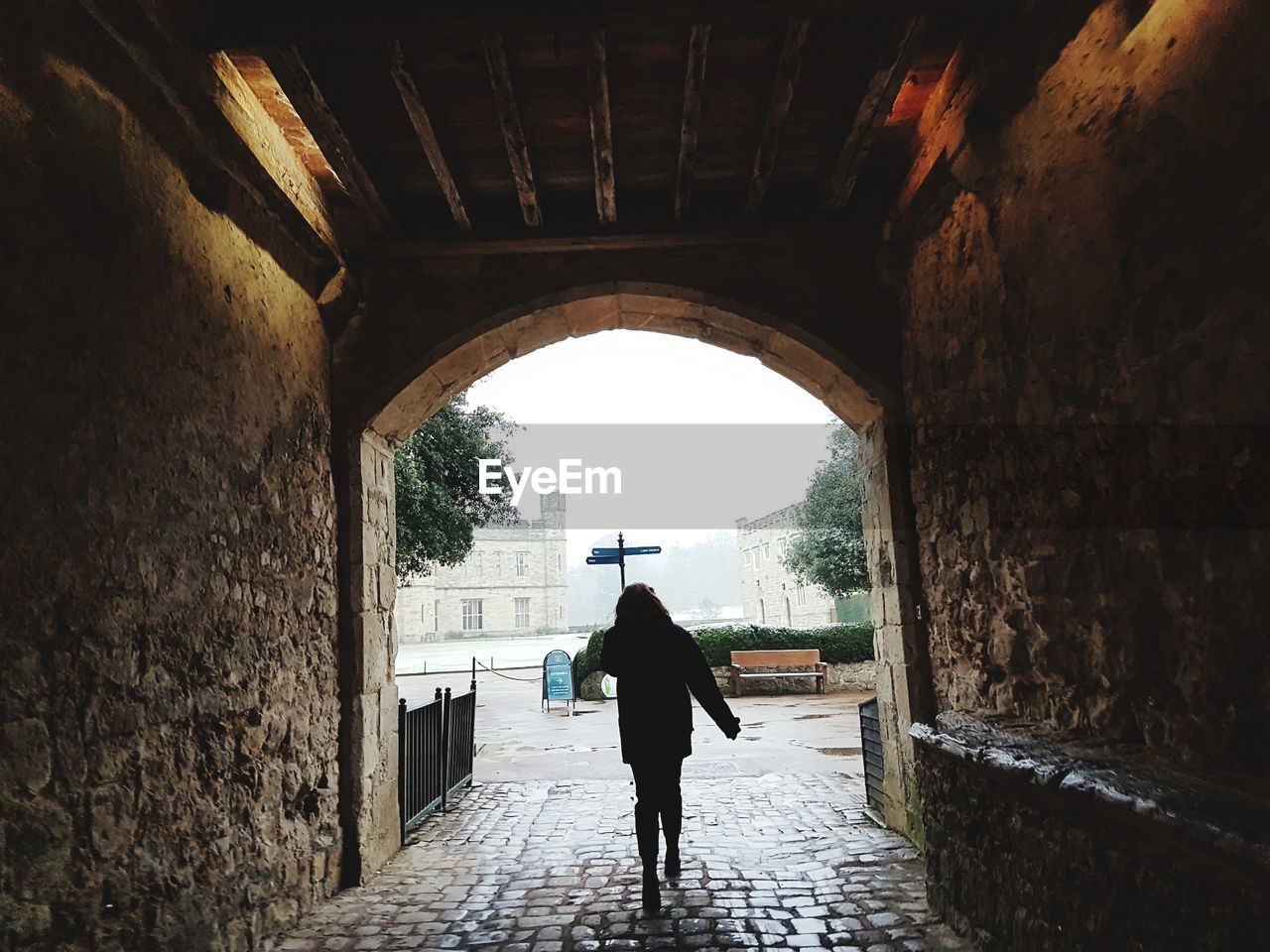 FULL LENGTH REAR VIEW OF MAN WALKING IN CORRIDOR