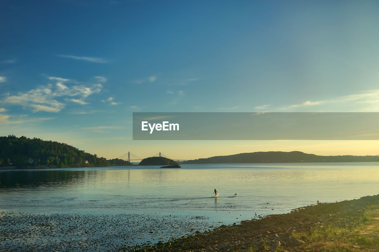 SCENIC VIEW OF BEACH AGAINST SKY AT SUNSET