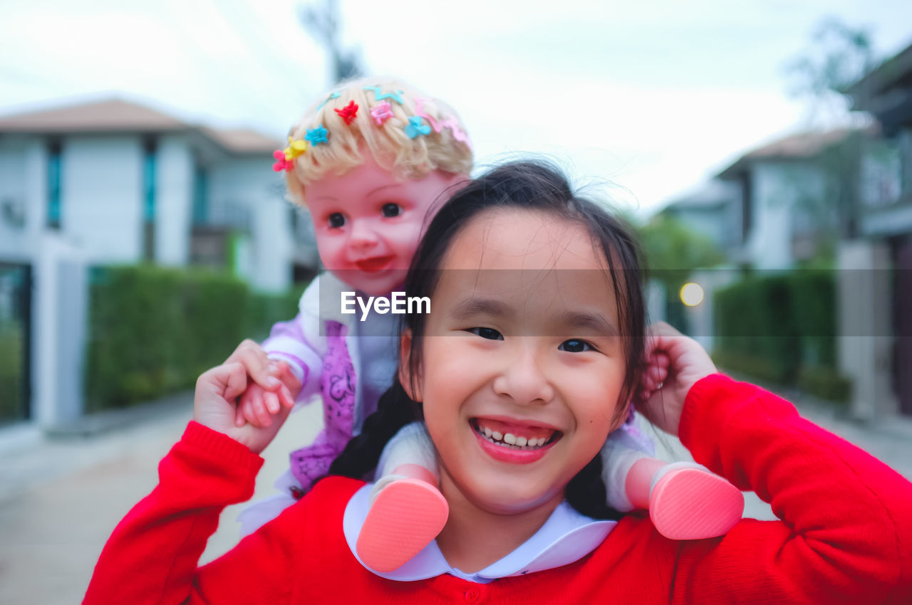 PORTRAIT OF A SMILING GIRL WITH MOTHER