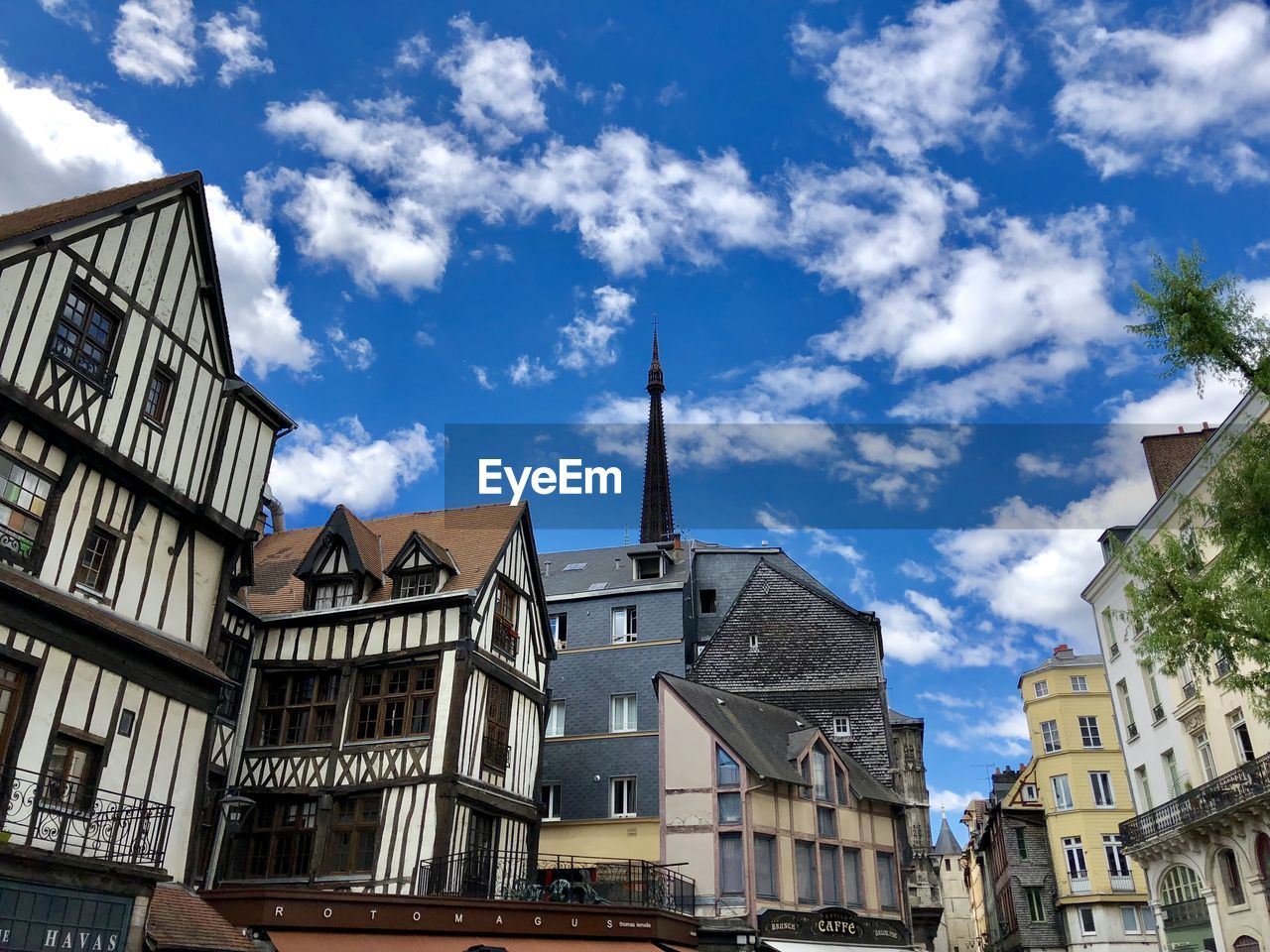 Low angle view of buildings in town against rouen, france