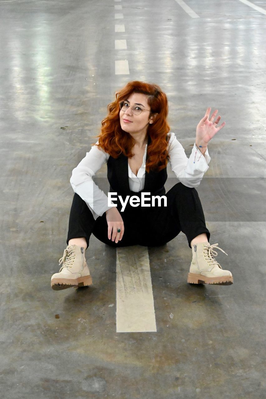 Portrait of a young woman sitting on floor