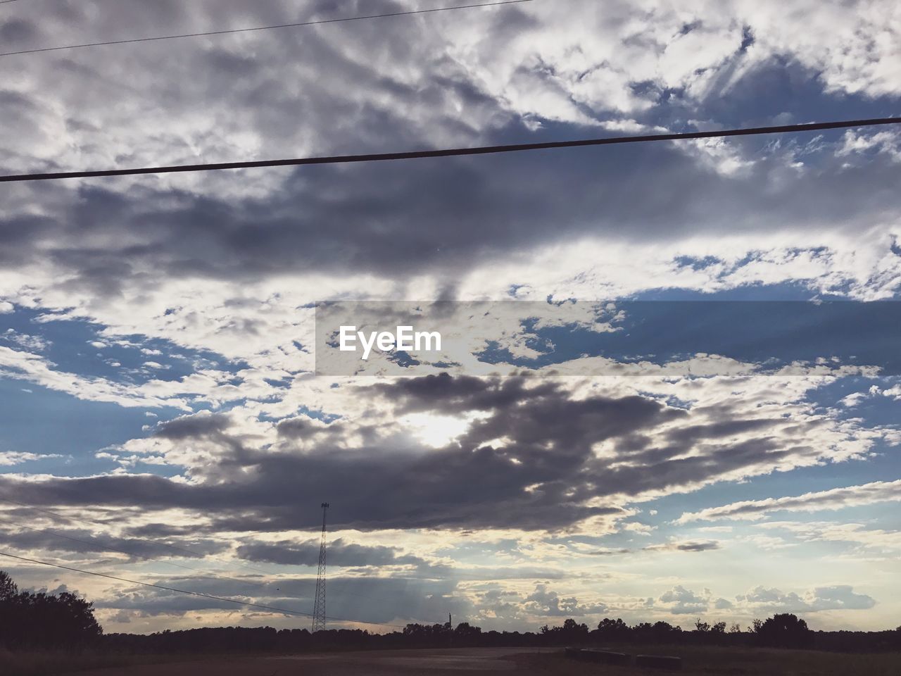 LOW ANGLE VIEW OF CLOUDY SKY OVER TREES