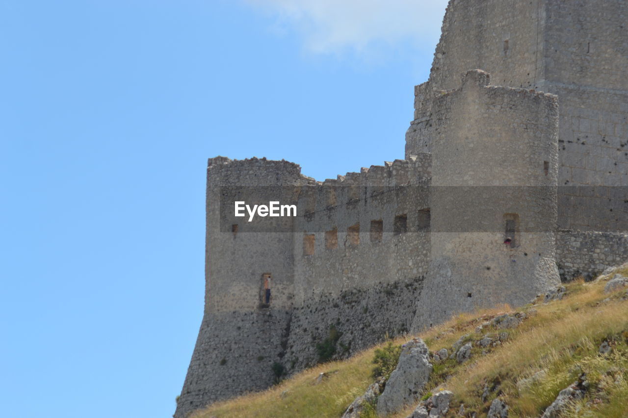 LOW ANGLE VIEW OF FORT AGAINST BLUE SKY