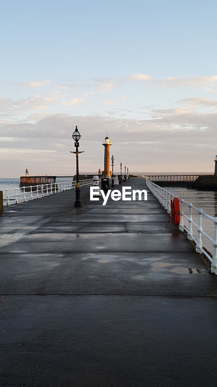 PIER AMIDST SEA AGAINST SKY