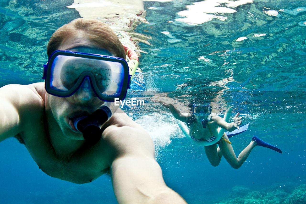 Couple snorkeling undersea