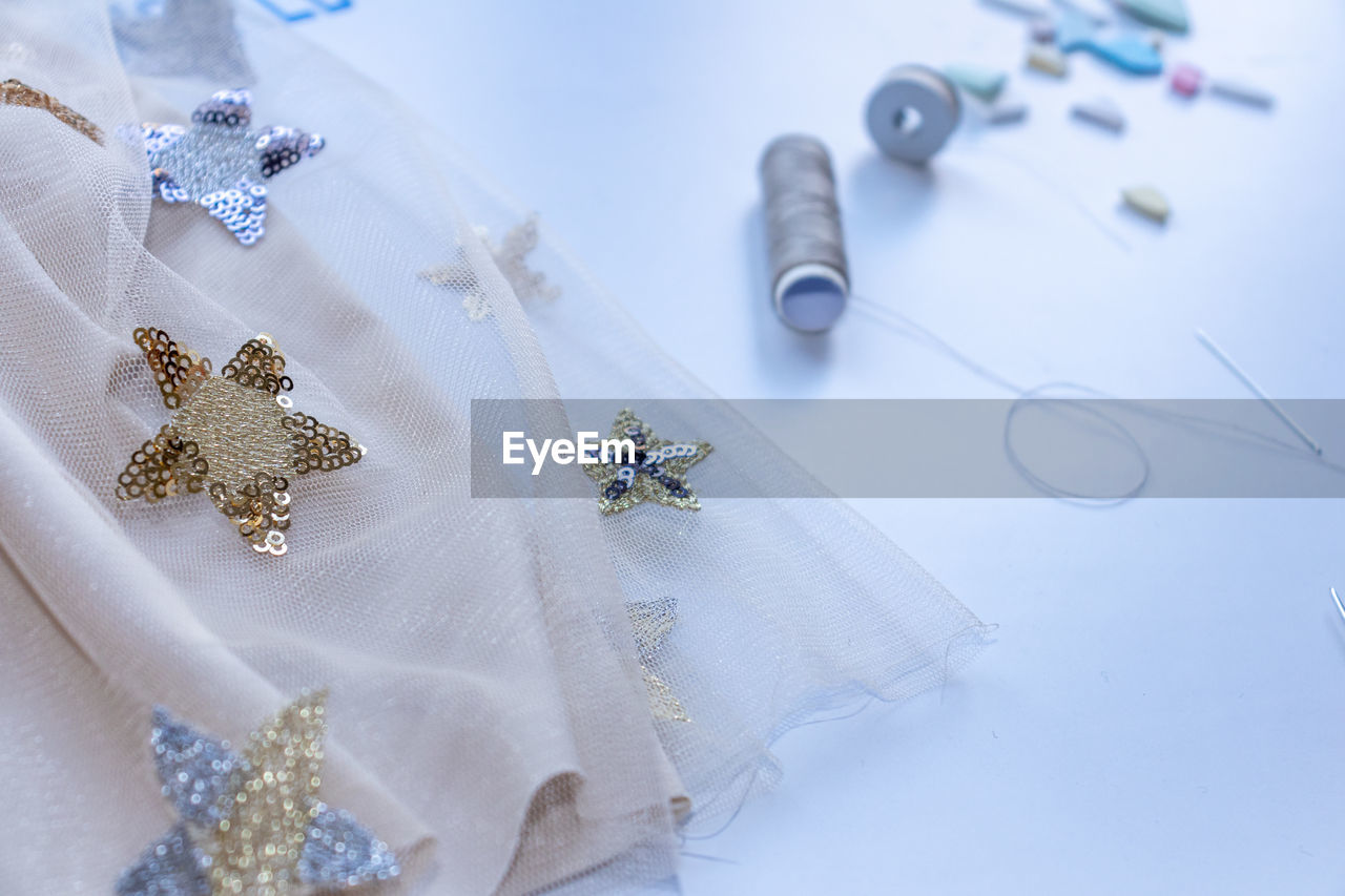 High angle view of christmas decorations on table. accessories on table in dressmaking workshop