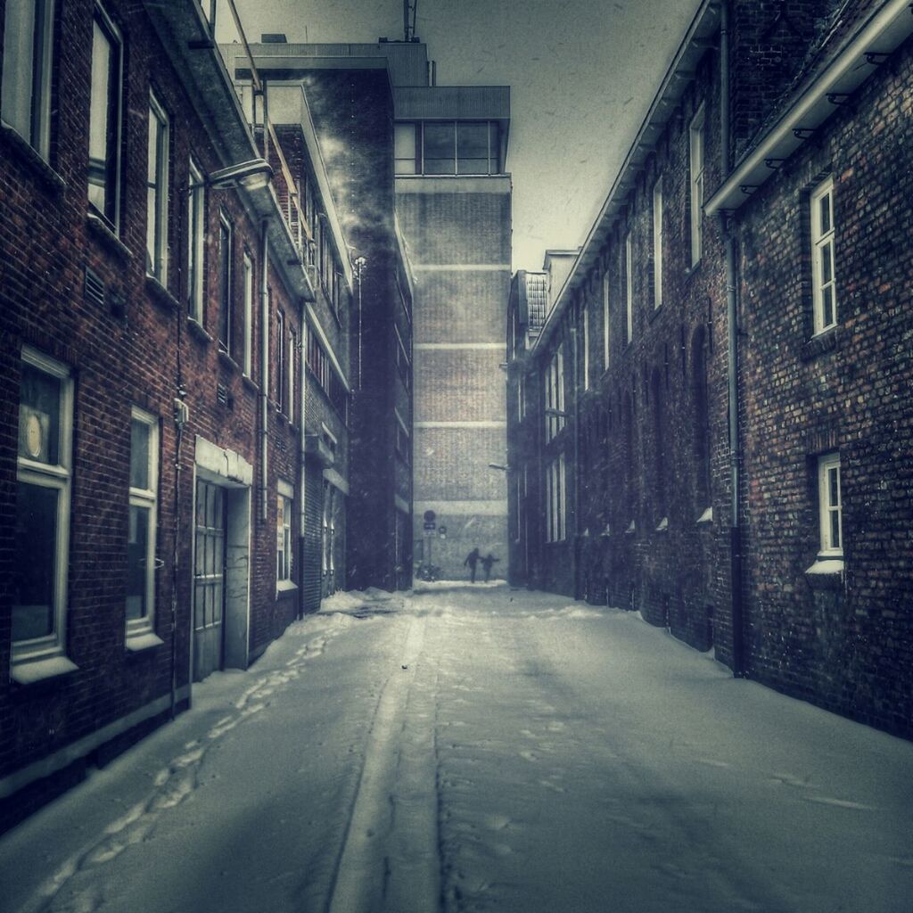 Empty alley along buildings