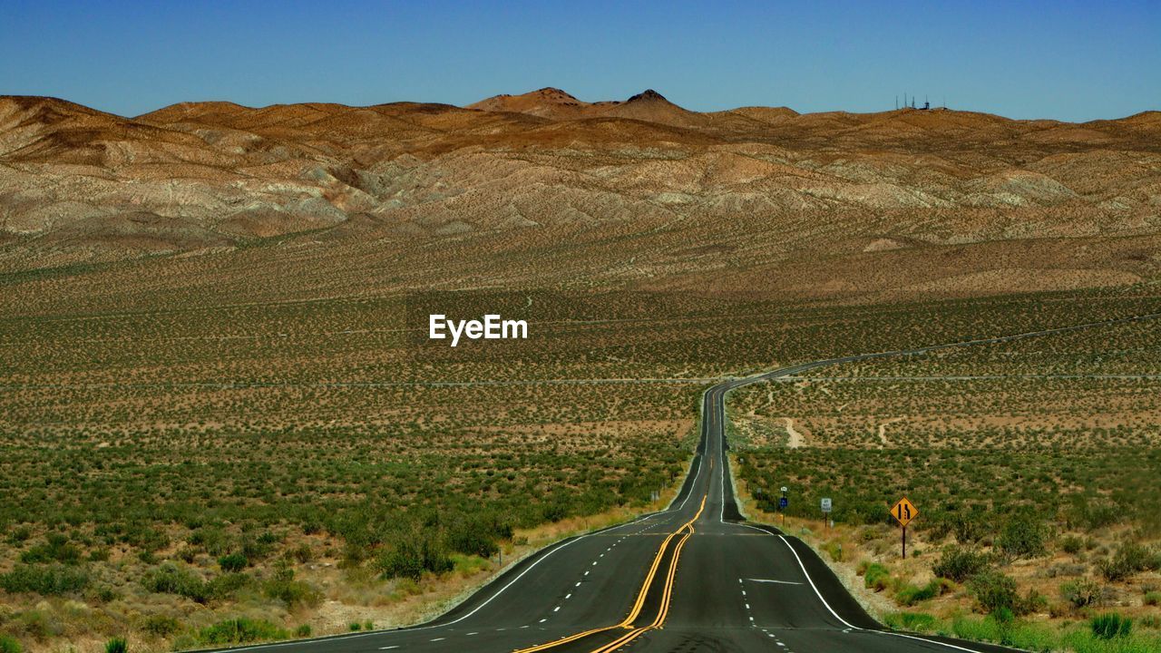 Road in desert against sky
