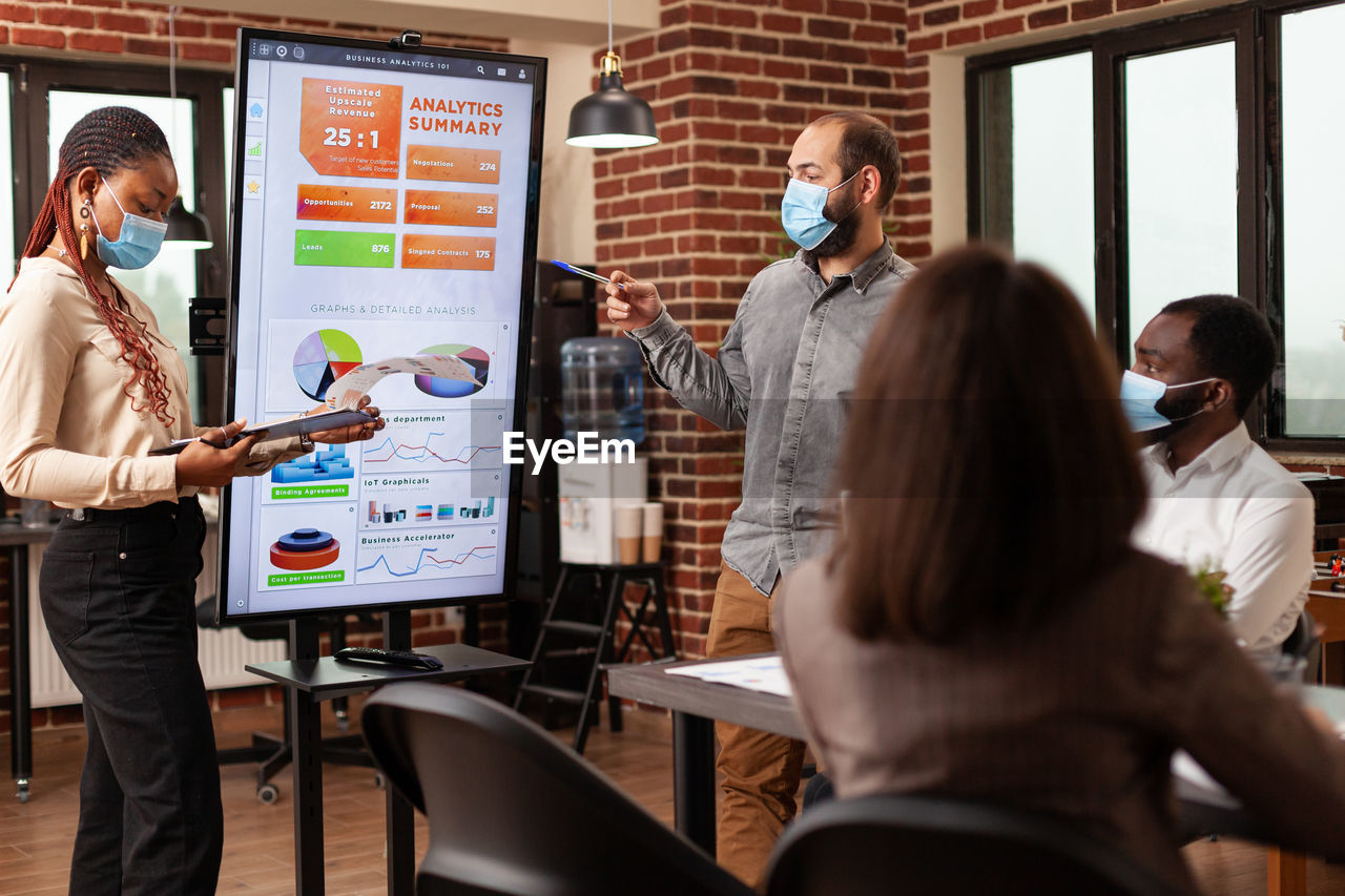 Business colleagues brainstorming during presentation