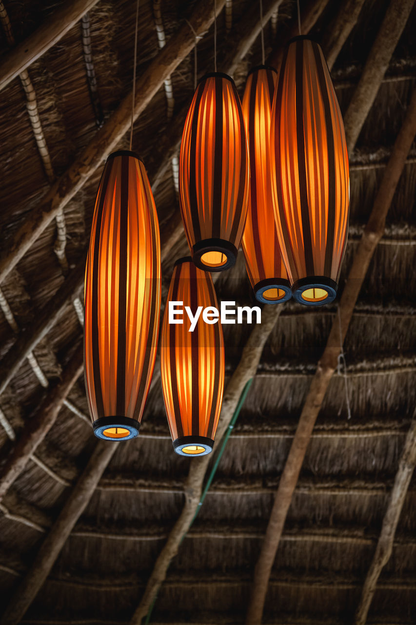 Low angle view of illuminated lanterns hanging on ceiling