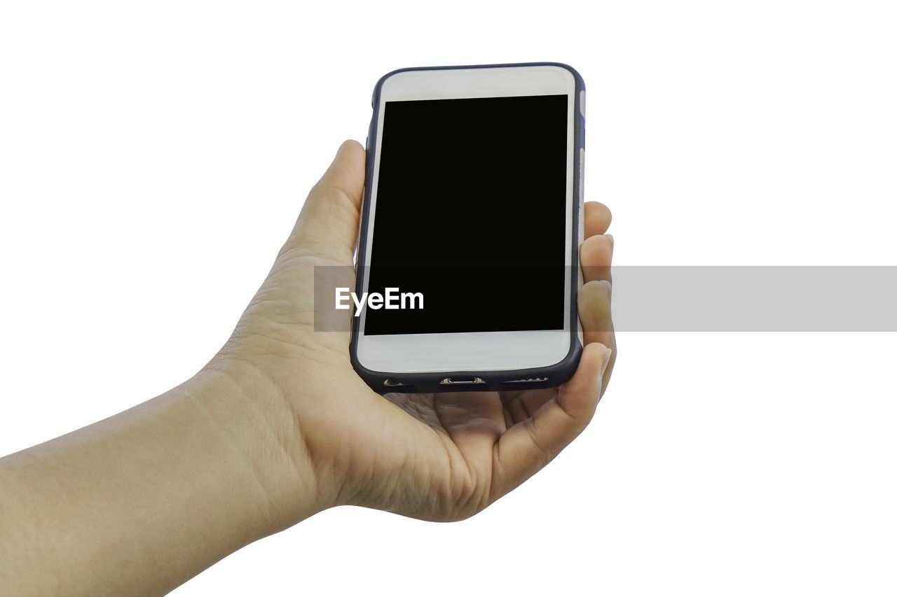Hand holding mobile phone against white background