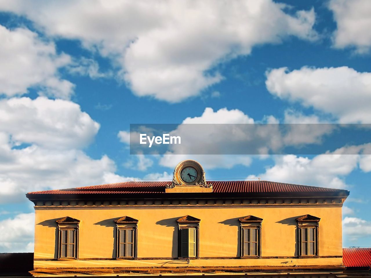 Low angle view of building against cloudy sky