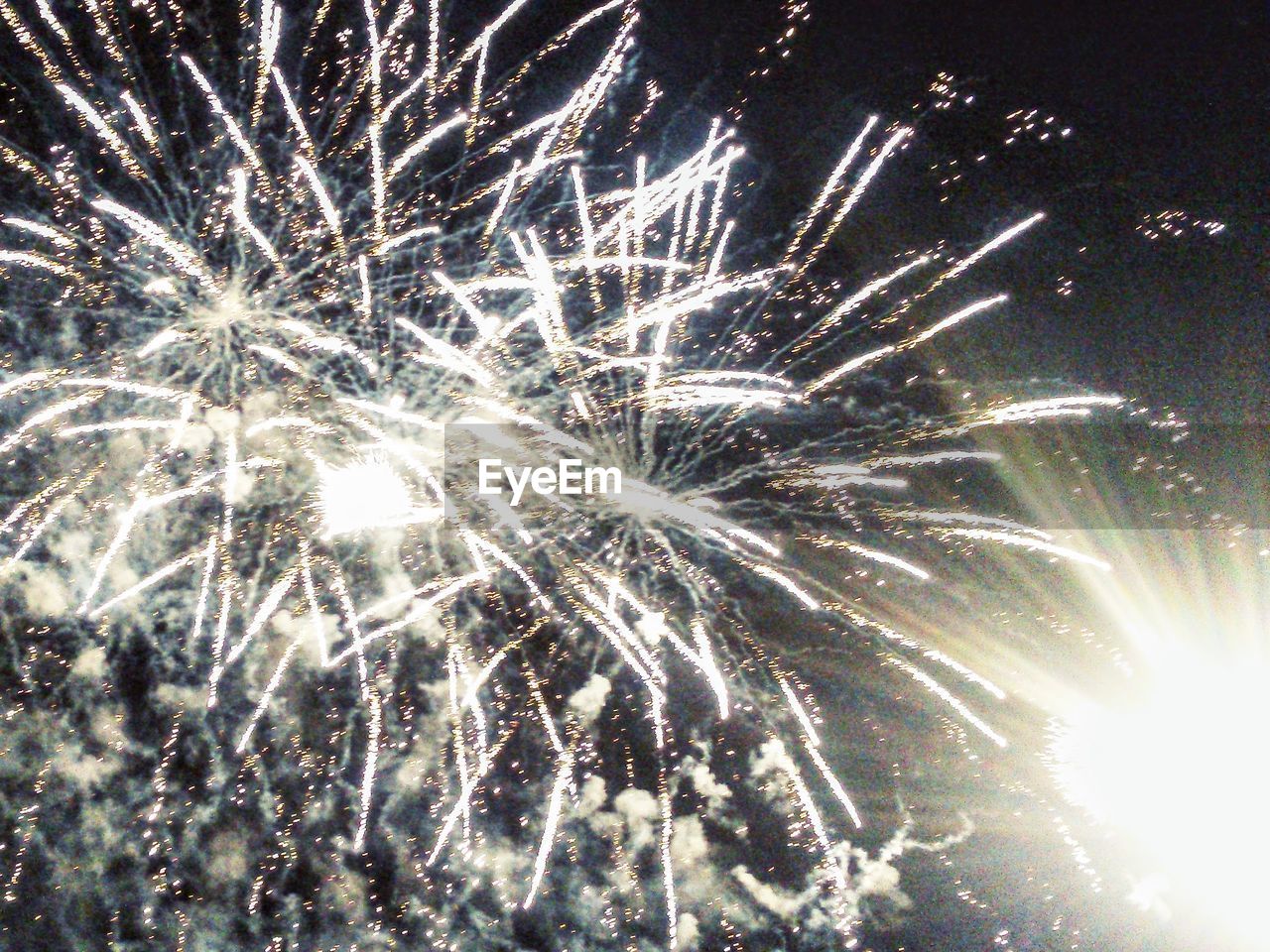 LOW ANGLE VIEW OF FIREWORKS EXPLODING