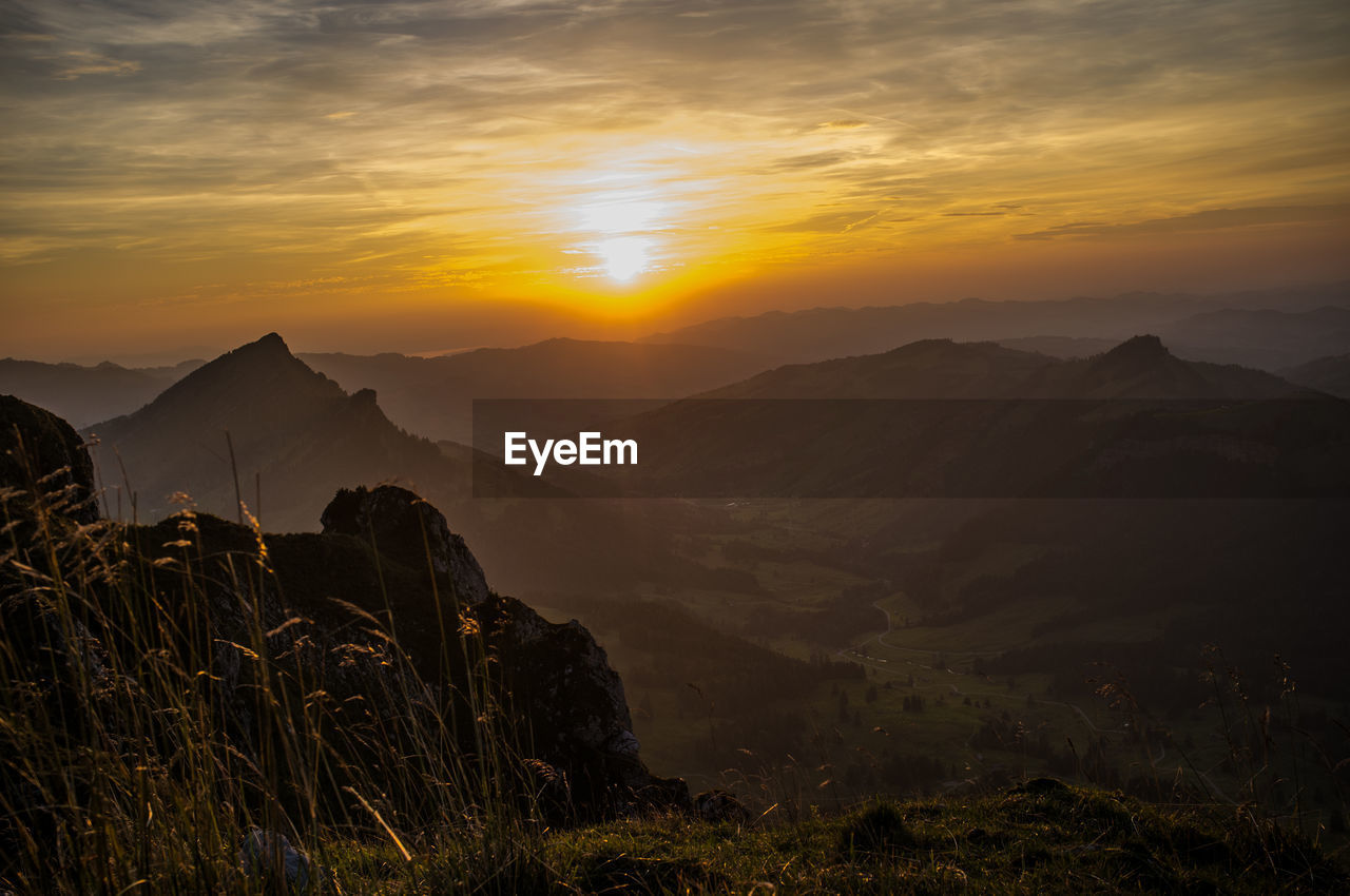 Scenic view of silhouette mountains against sky during sunset