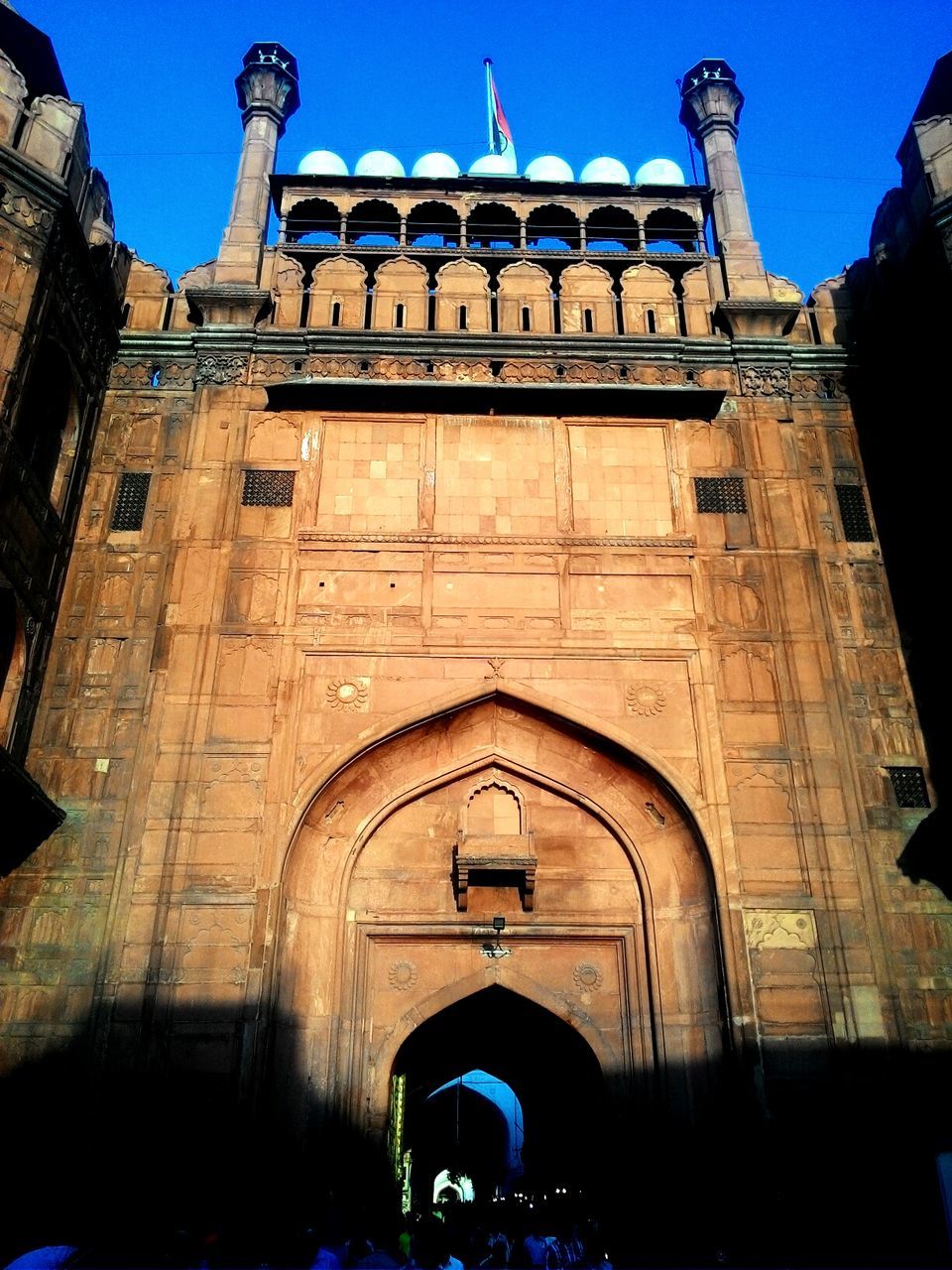 Low angle view of red fort against clear sky