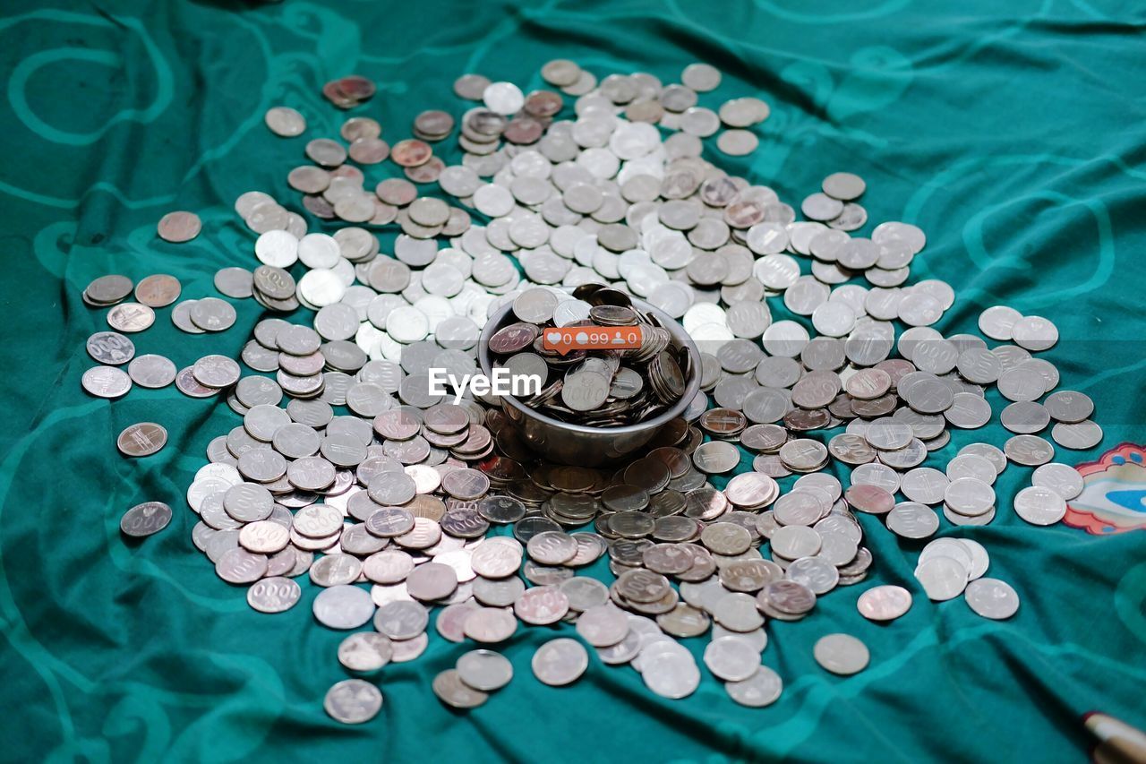 High angle view of coins on bed