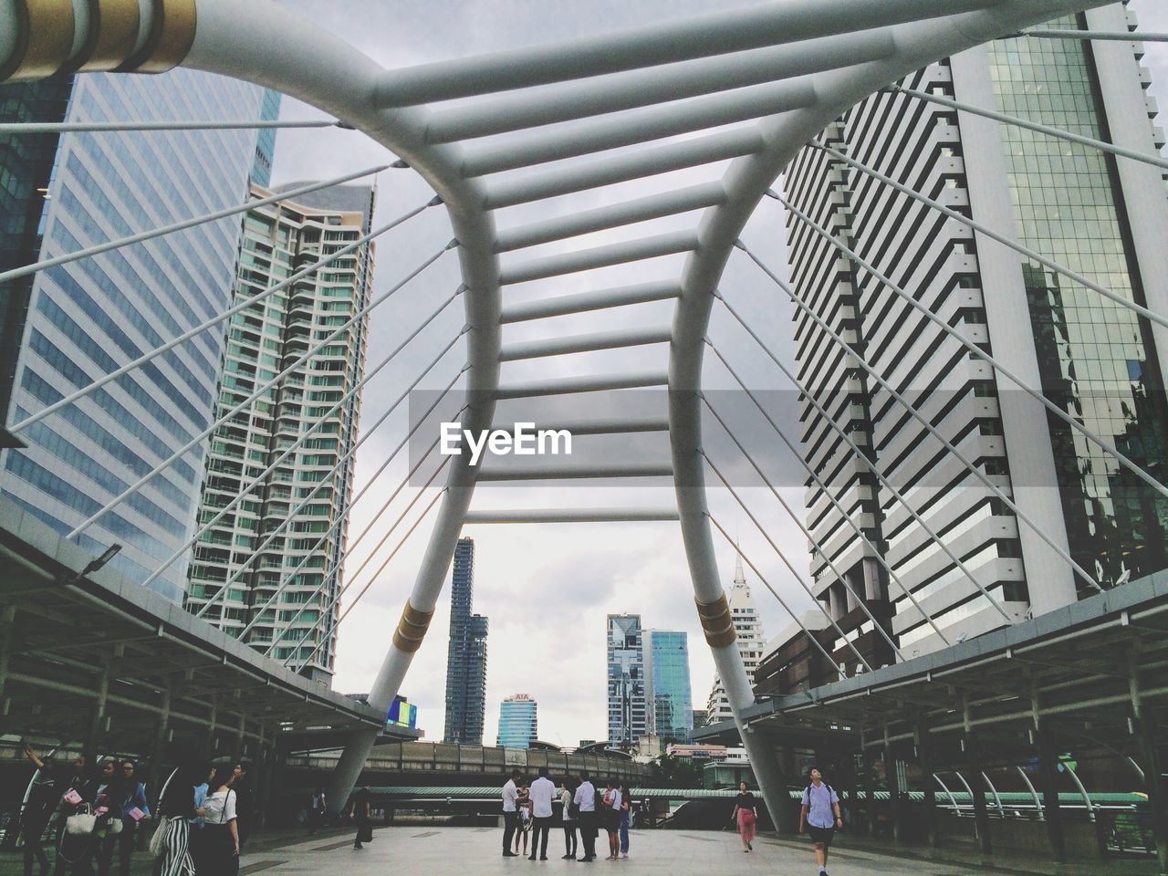 Low angle view of bridge amidst buildings