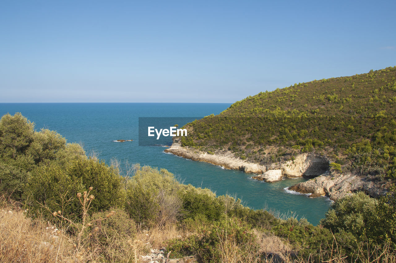 Scenic view of sea against clear blue sky