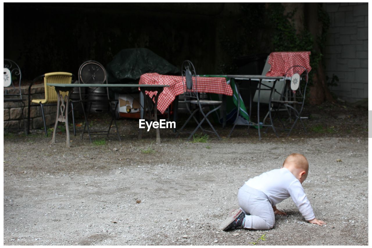 High angle view of boy crawling on sand
