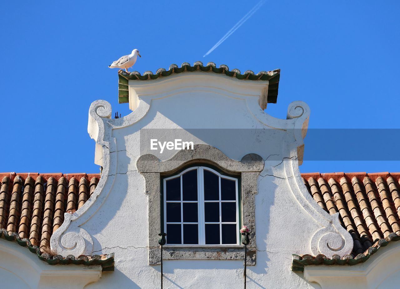 Low angle view of building against blue sky