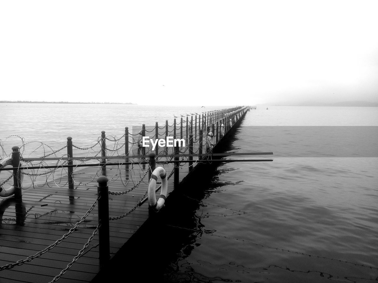 Pier over sea against clear sky