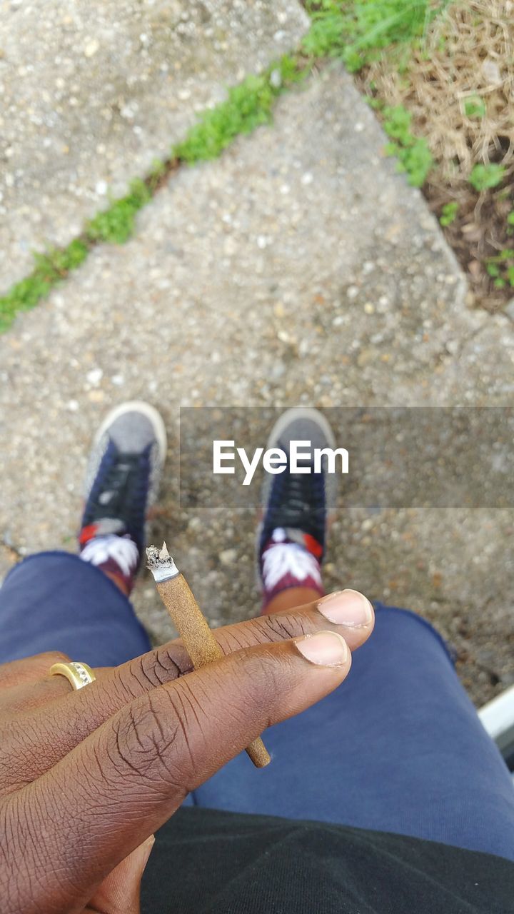 LOW SECTION OF WOMAN STANDING ON GROUND