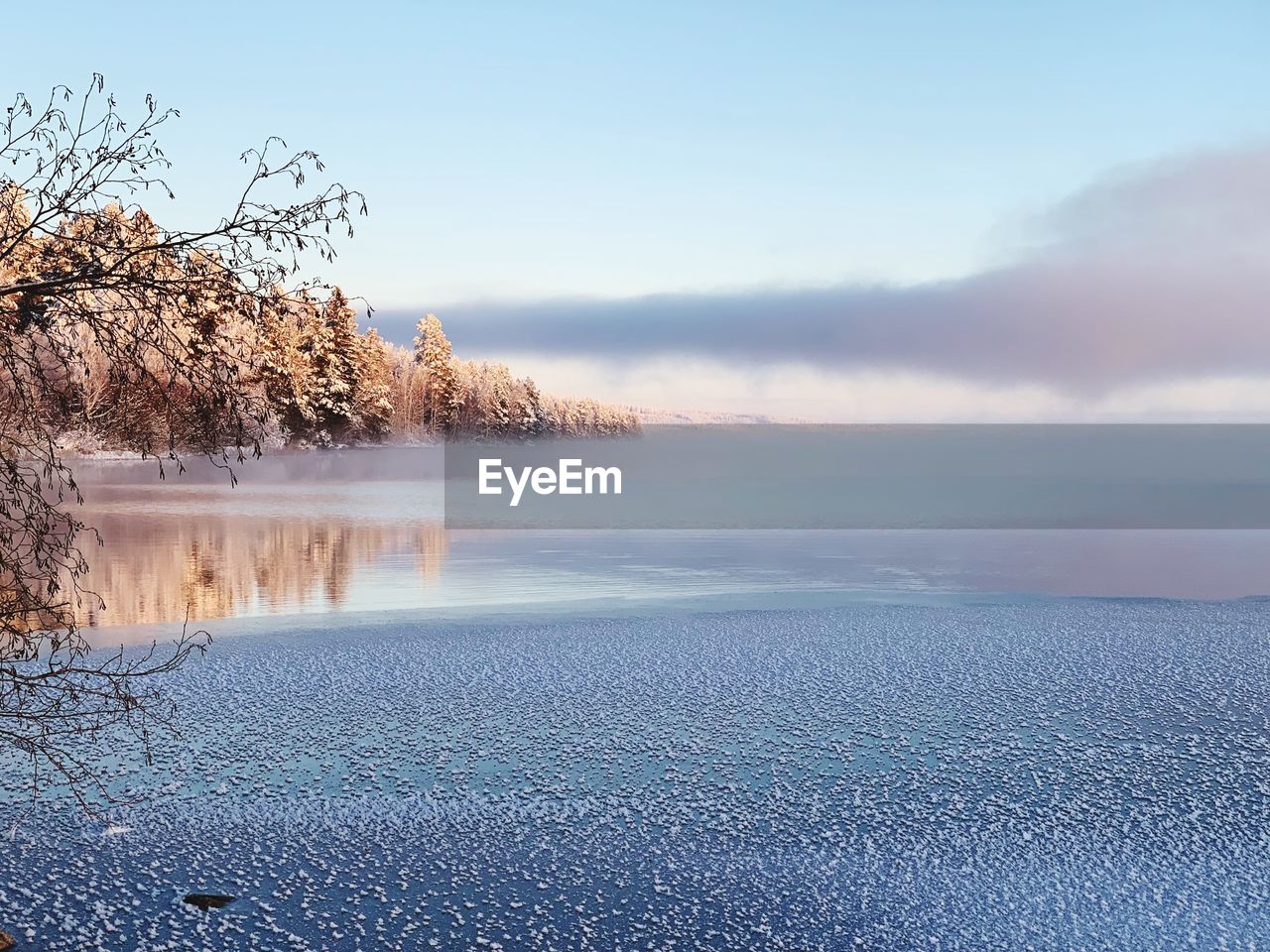 Scenic view of lake against sky during winter