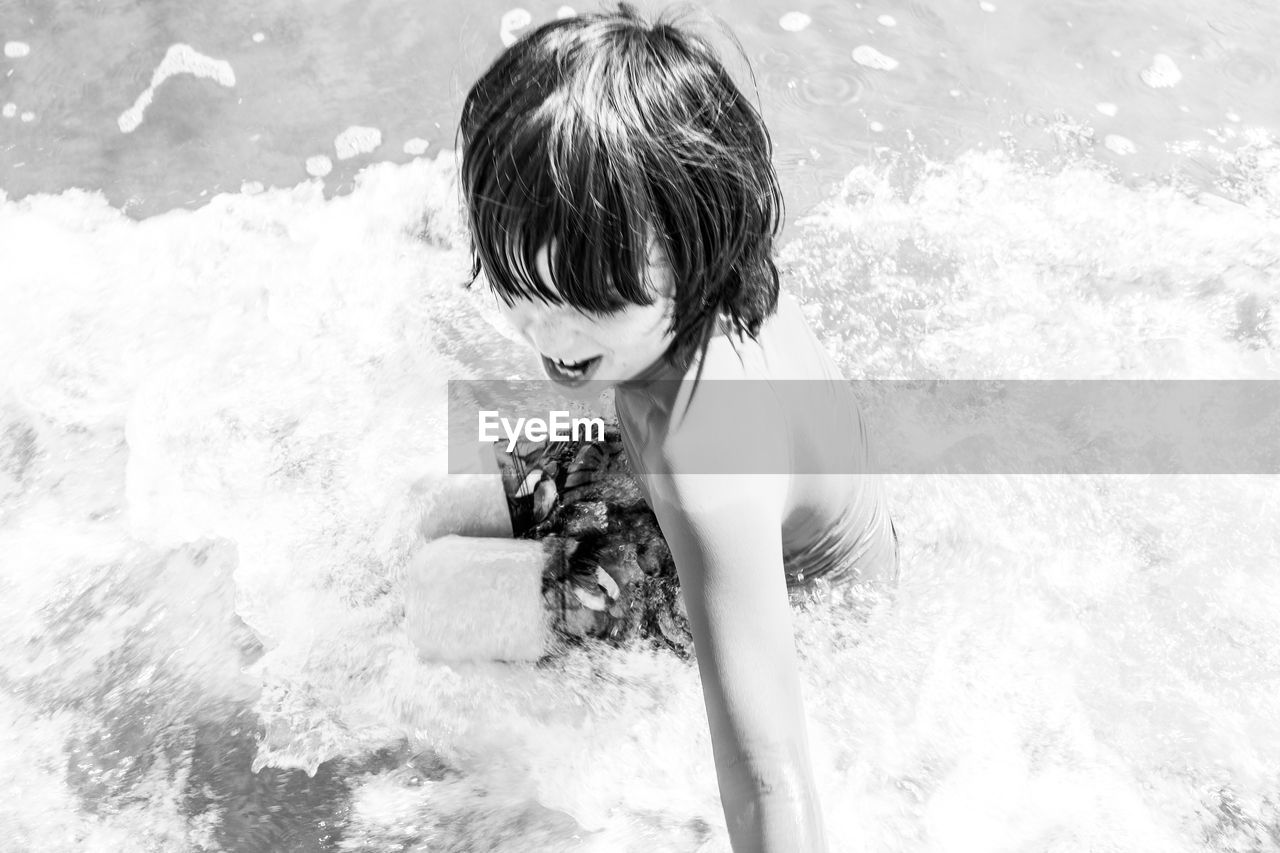 High angle view of boy in the sea
