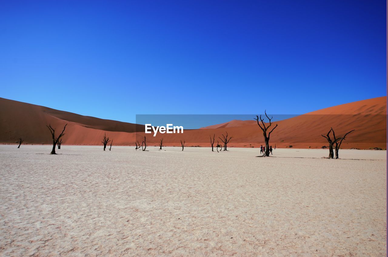 View of desert against clear blue sky