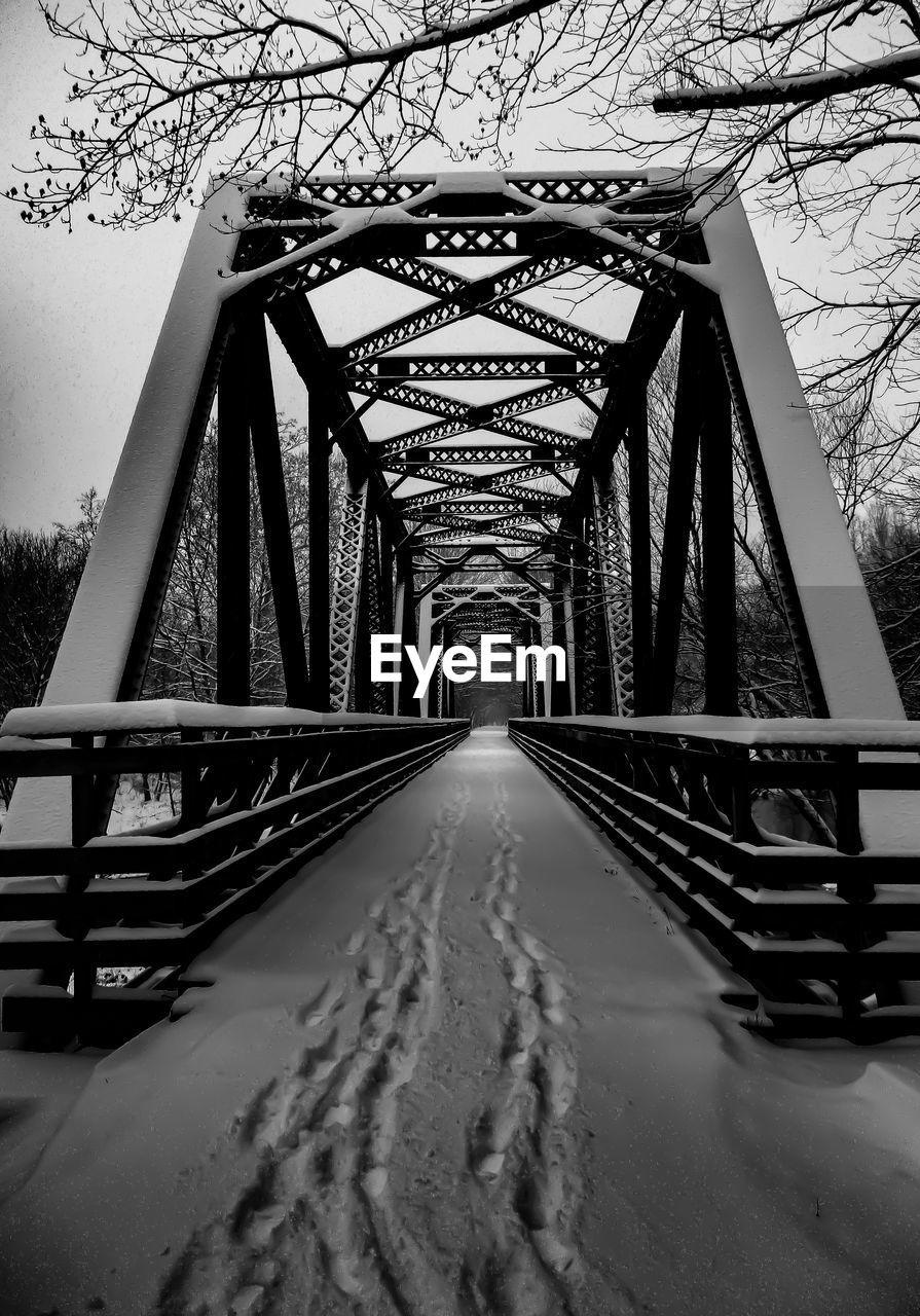 Footbridge over snow-covered bridge