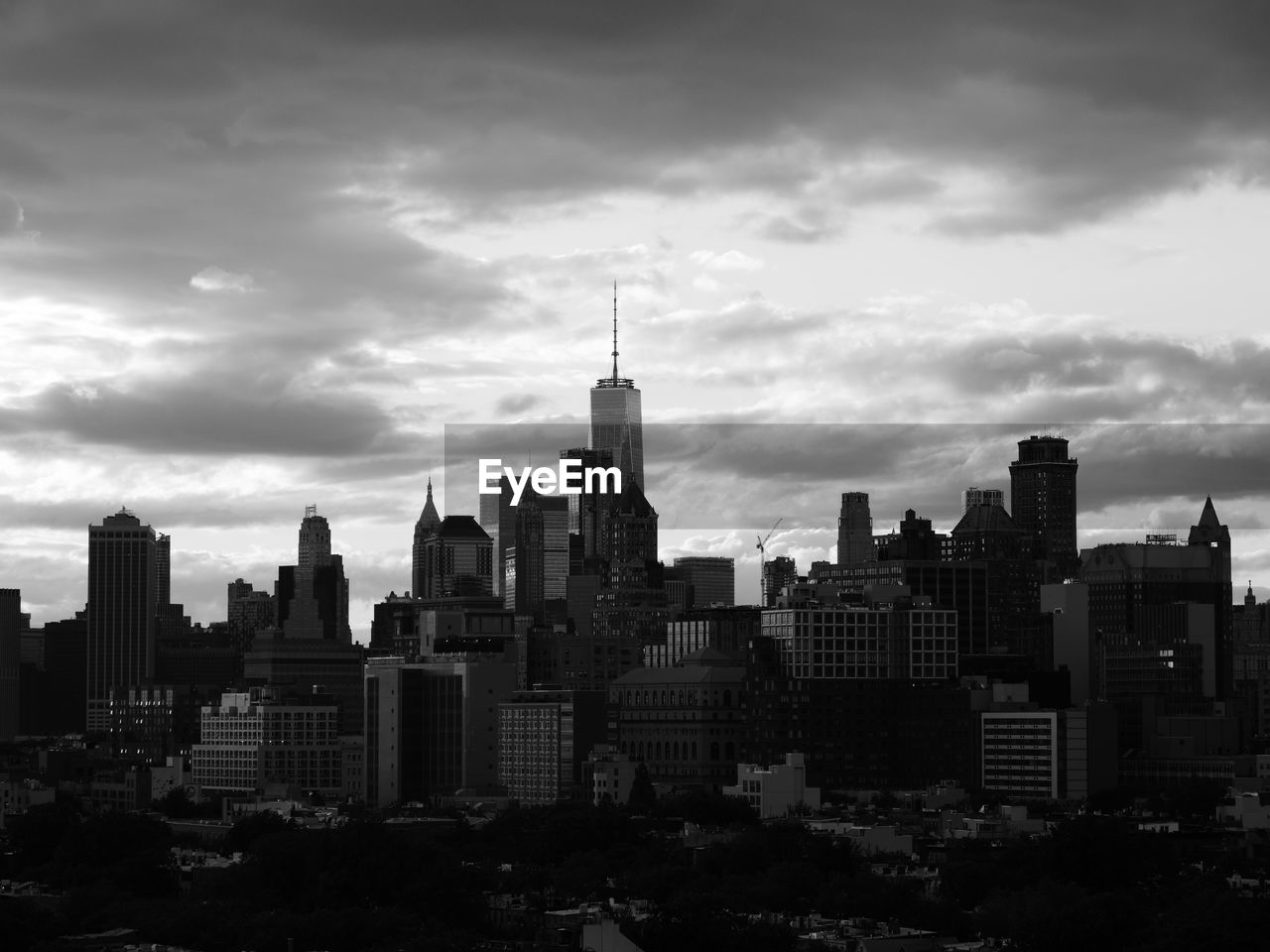 View of cityscape against cloudy sky