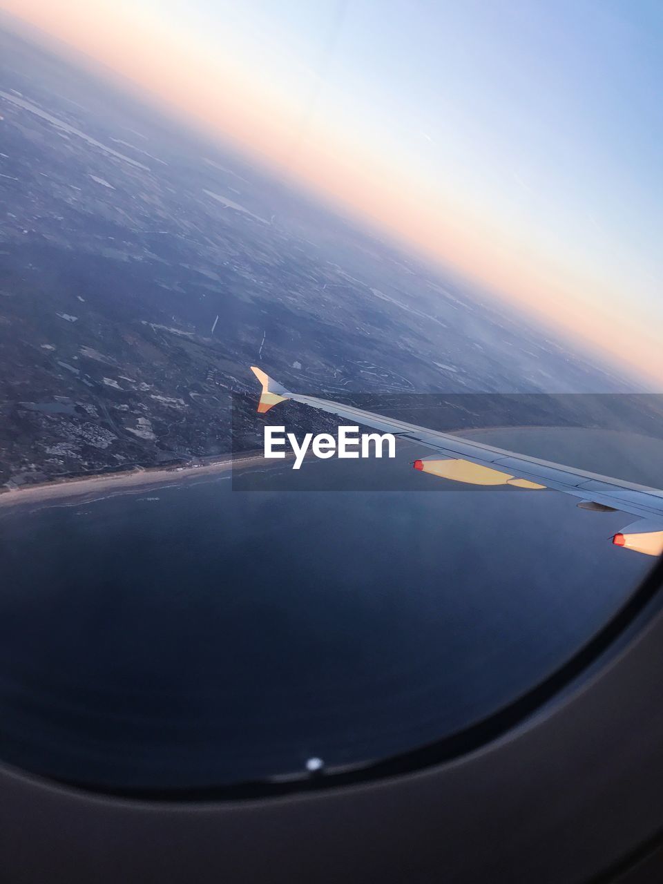 AERIAL VIEW OF AIRPLANE WING OVER SEA