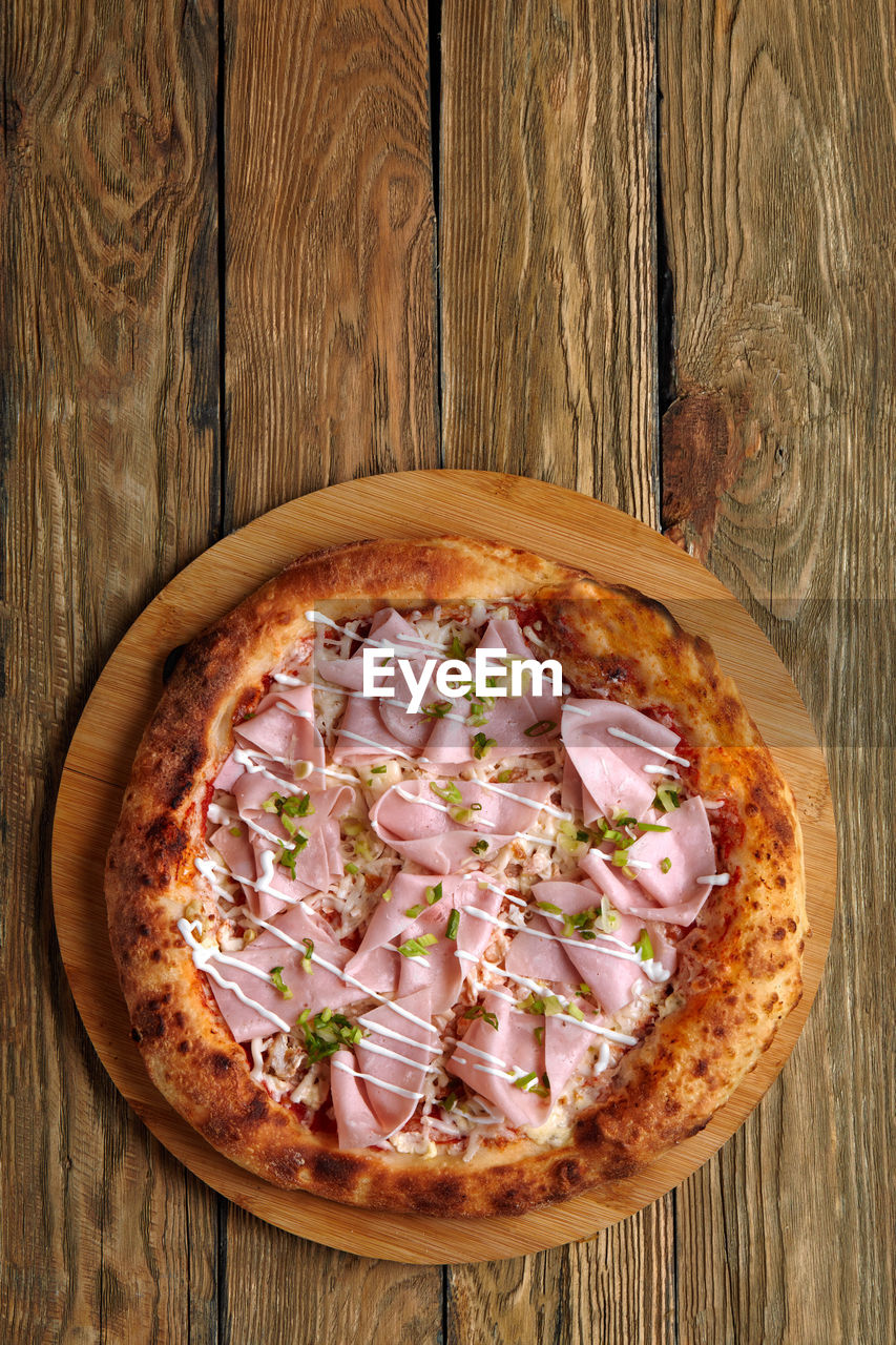 high angle view of pizza on wooden table