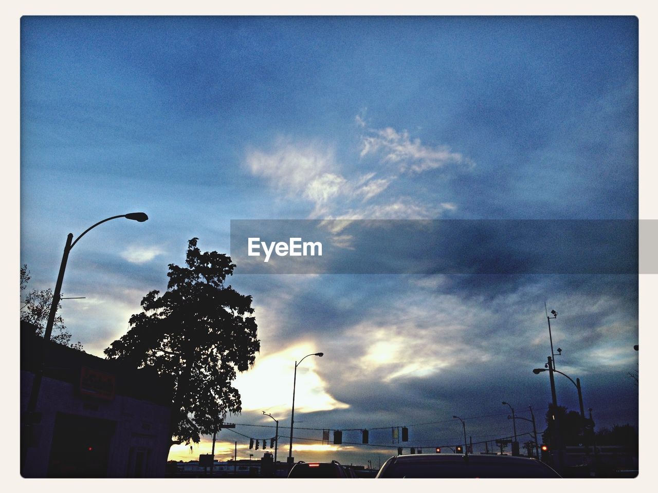 LOW ANGLE VIEW OF CLOUDY SKY OVER STREET