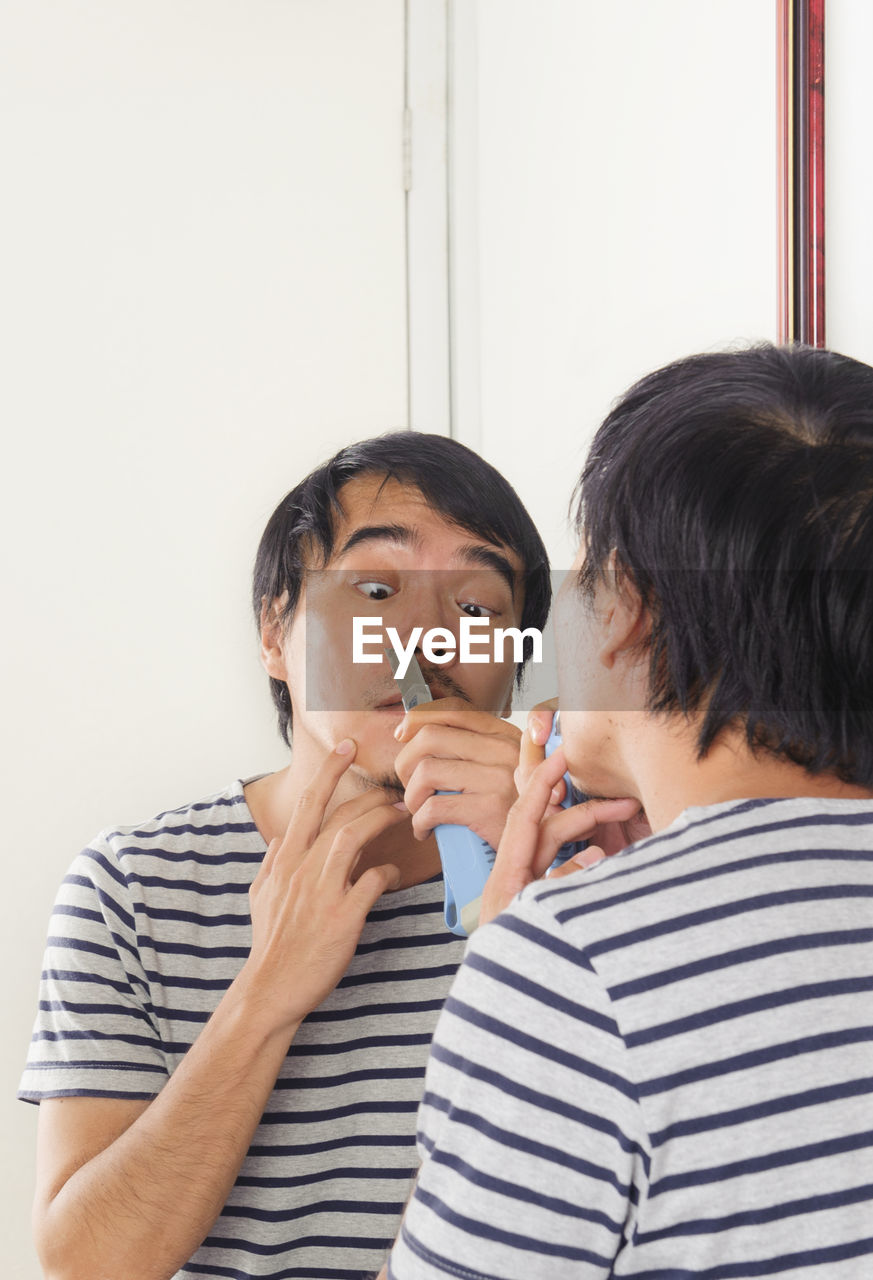 Man shaving at home