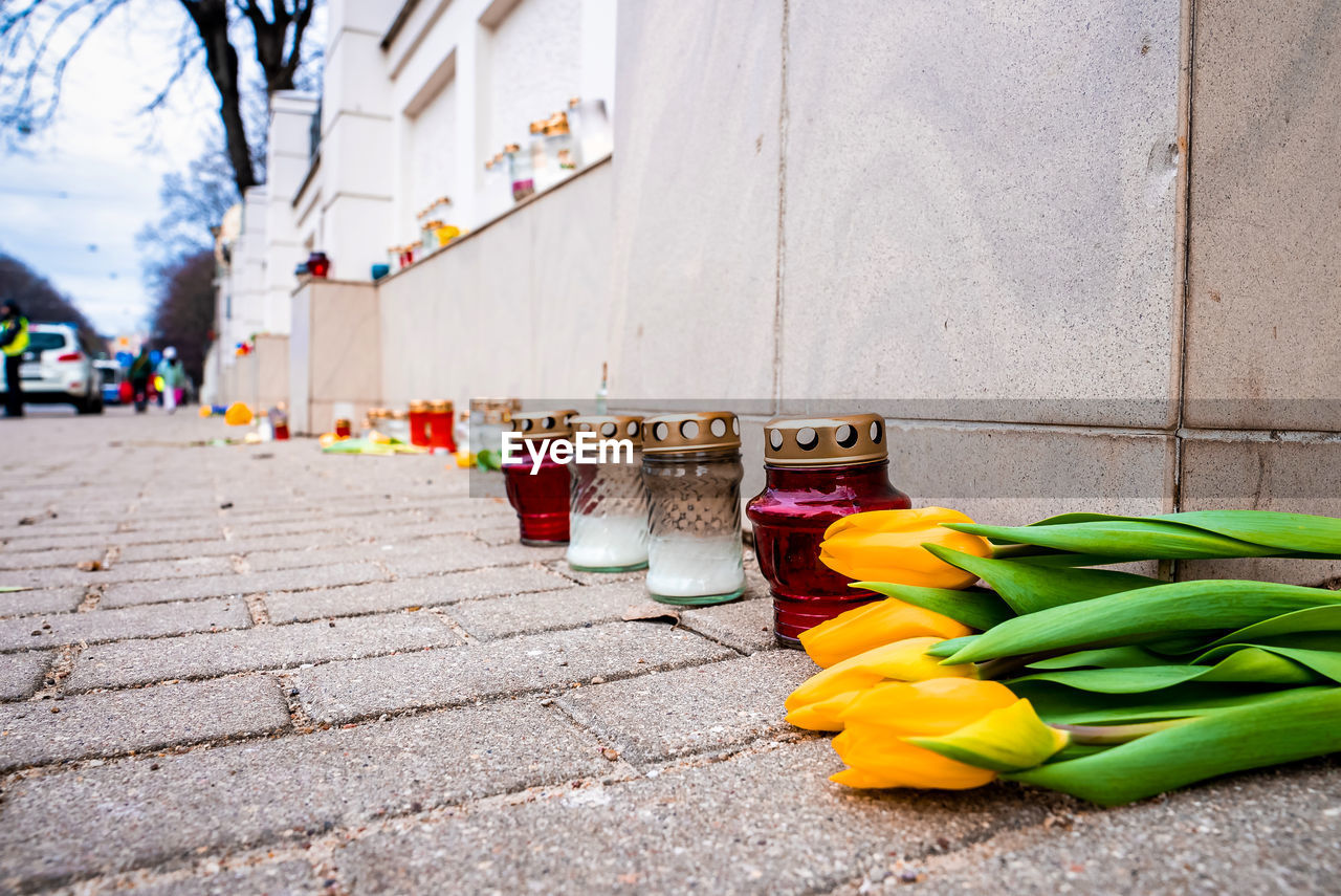 Thousands candles and flowers standing on the street during the war in ukraine