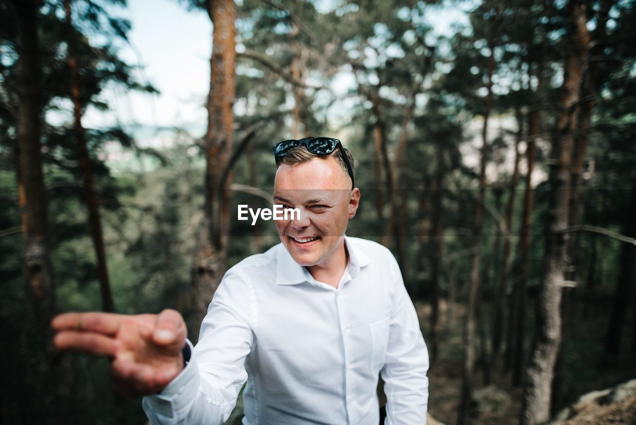 Man gesturing at forest