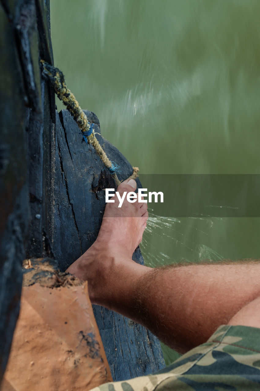 Low section of man on boat at sea