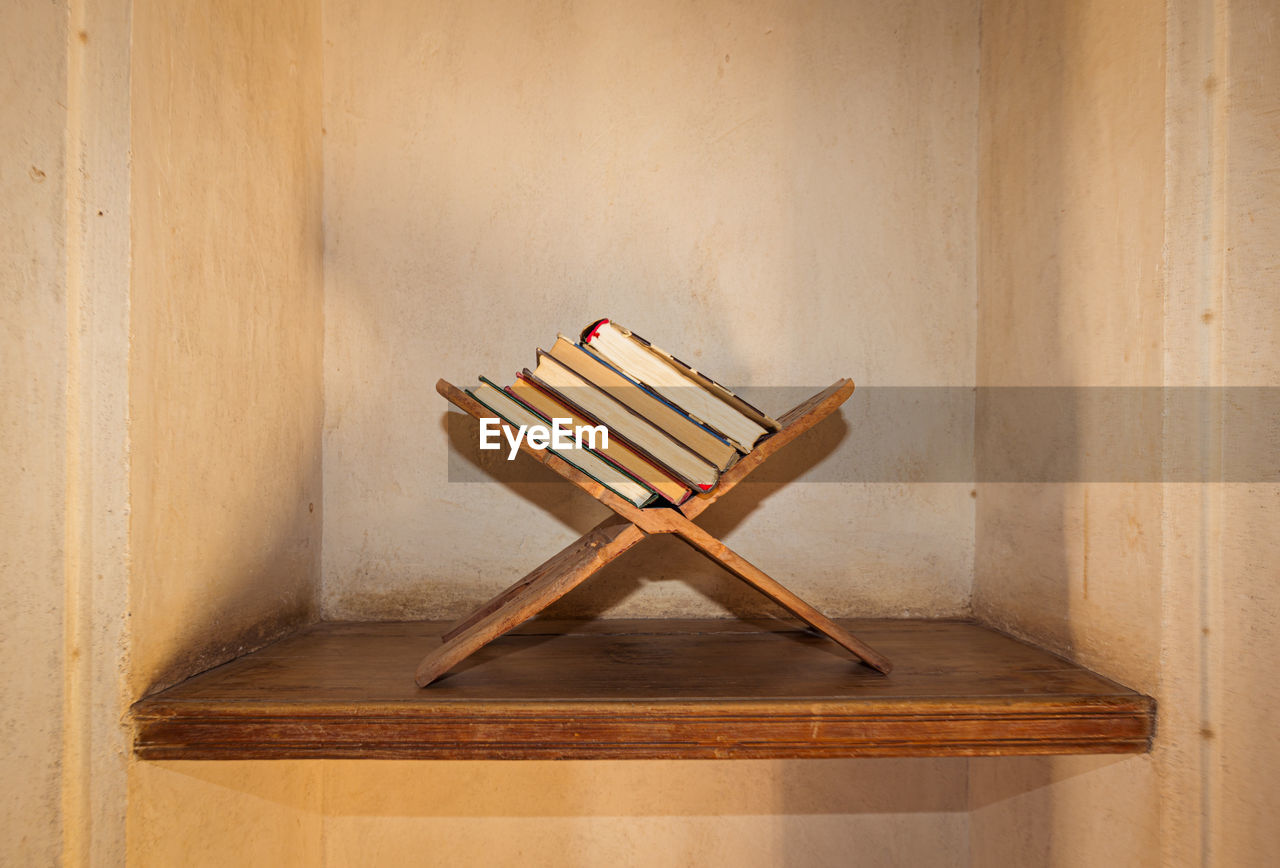 Close-up of books on wooden plank