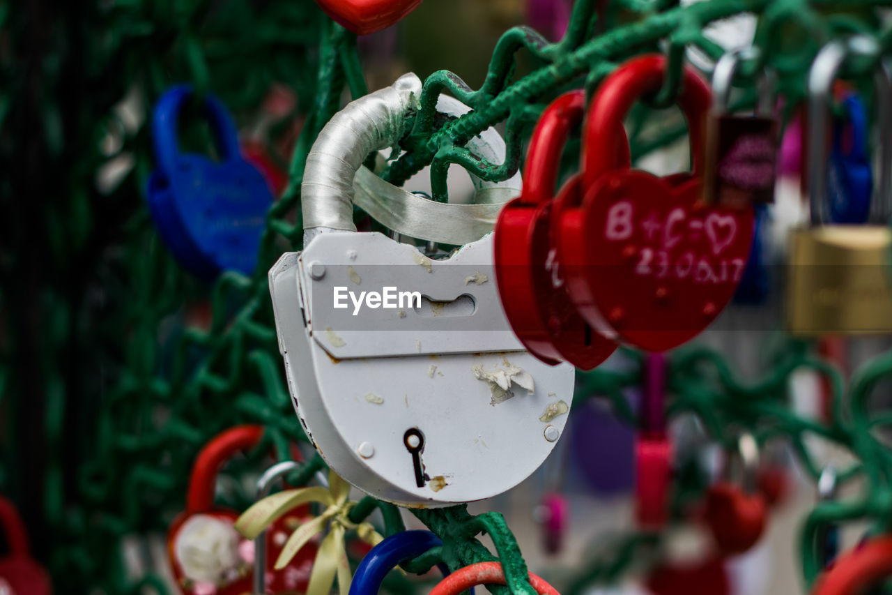 Close-up of padlocks hanging on metal wire