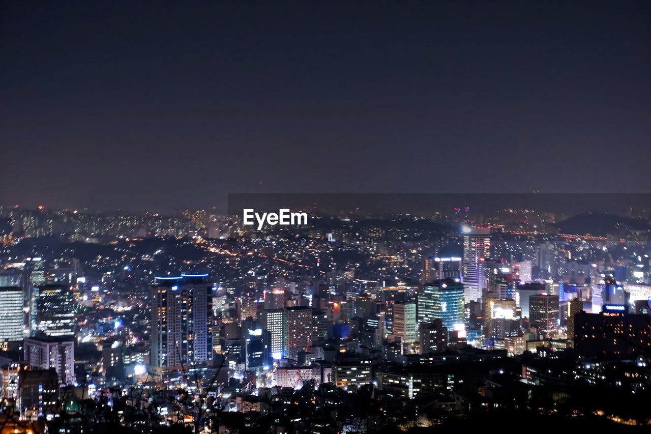 Illuminated cityscape against sky at night. taken from the namsan tower in south korea, on winter. 