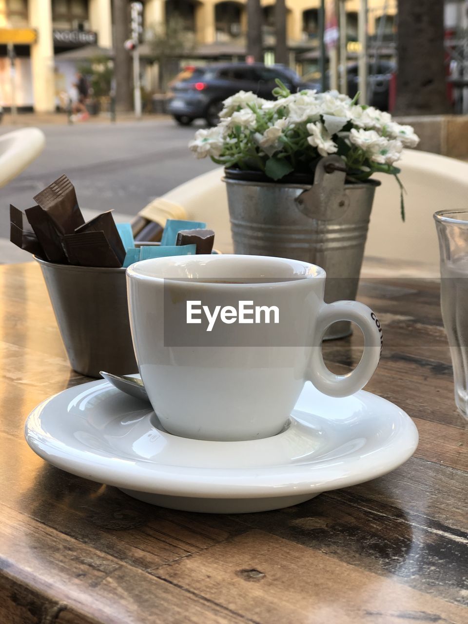 Close-up of coffee on table at outdoor cafe in city